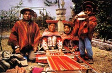  A weaving family of Chincheros, Peru. The loom is warped to weave a poncho. 